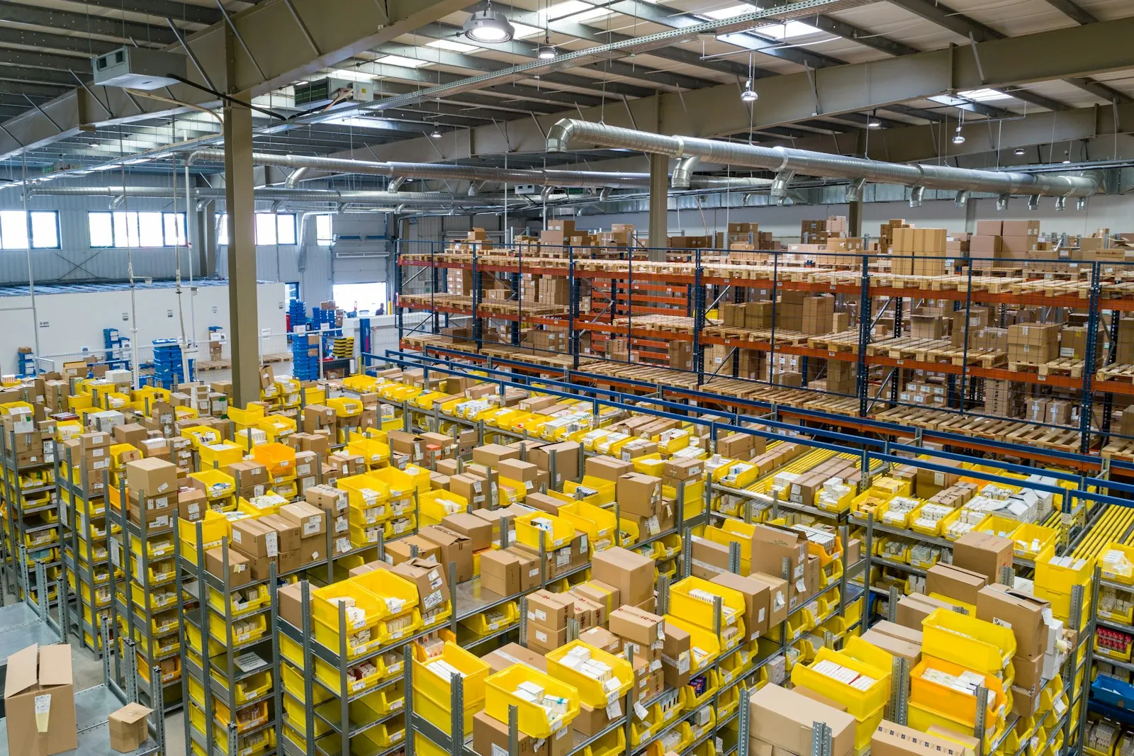 Aisles of a busy fulfilment warehouse stacked with parcels