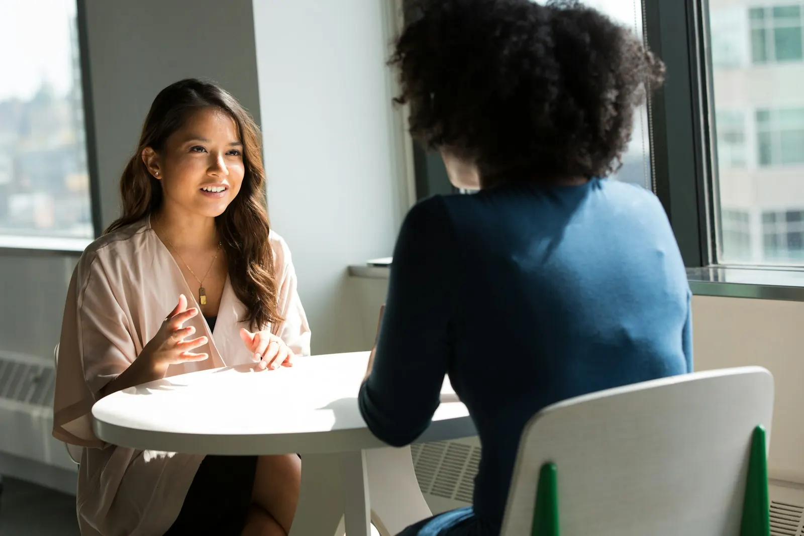 A real-estate advisor in conversation with a client at a table