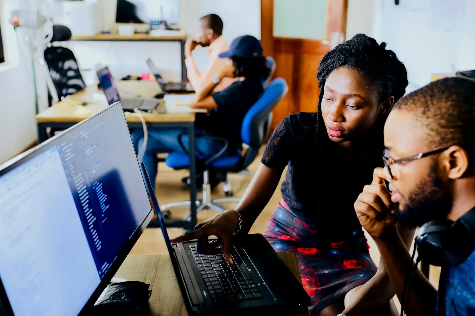 Software engineers reviewing code together on screens