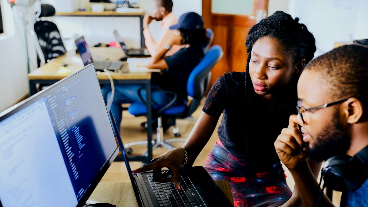 Software engineers reviewing code together on screens